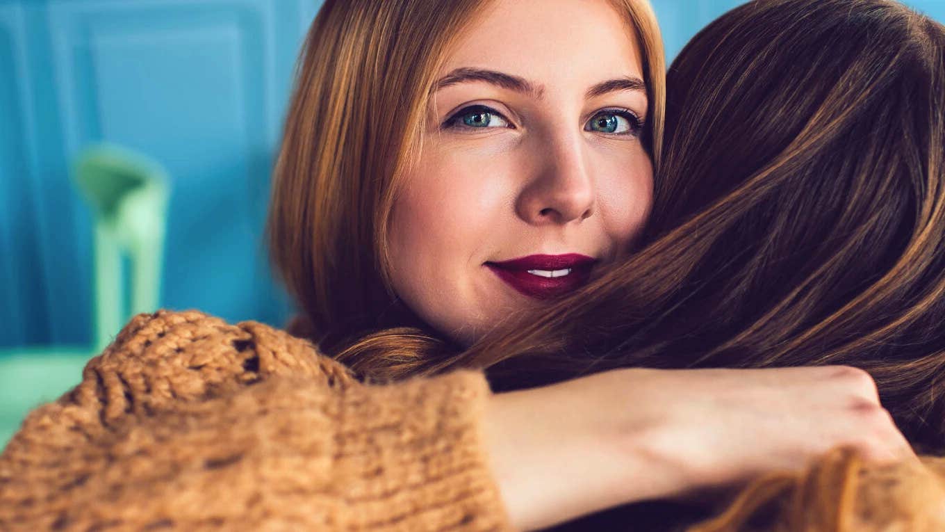 brilliant woman hugging friend avoiding boring conversation