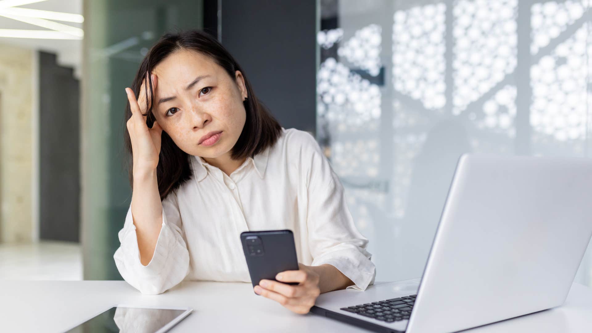 woman at her desk feeling stressed