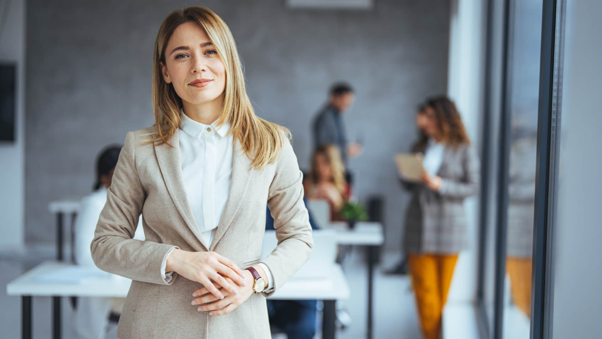 Confident young woman standing in a modern office