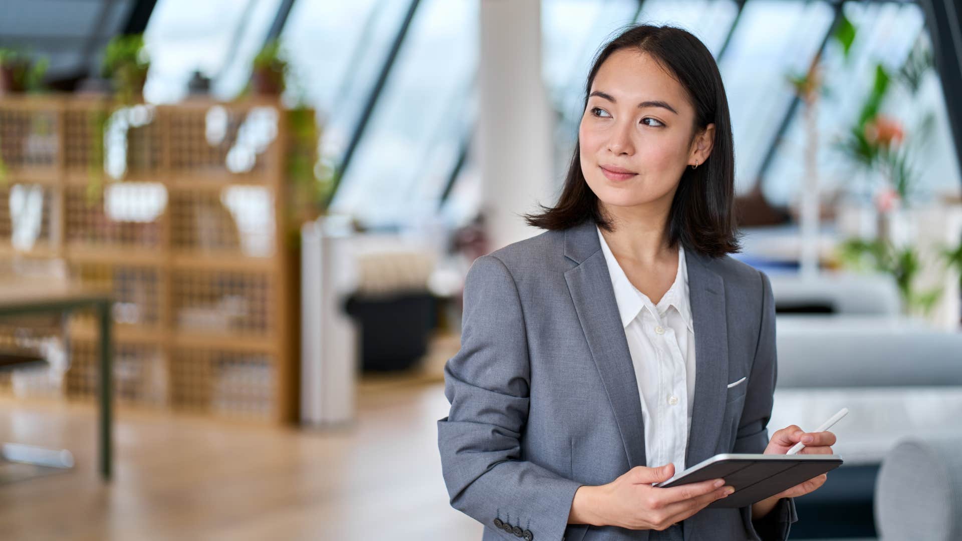 businesswoman standing in office holding a tablet