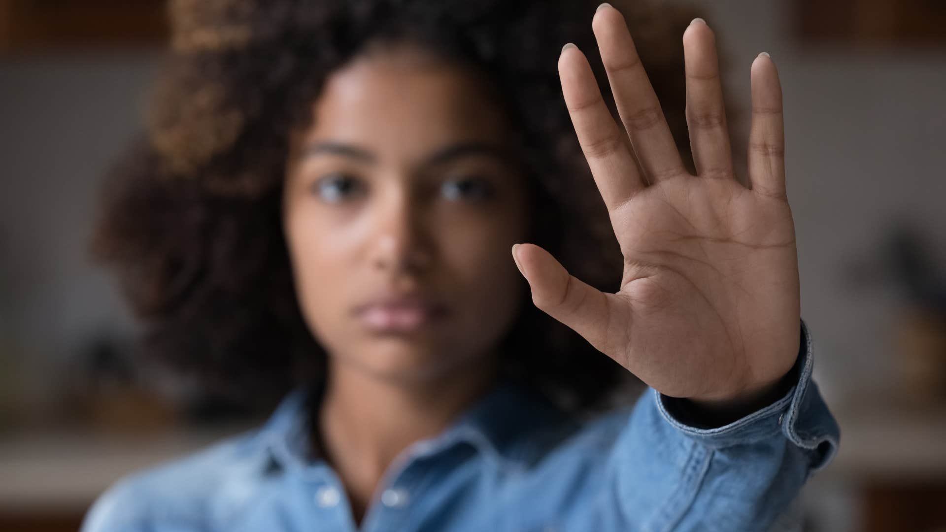 woman holding up hand to say no