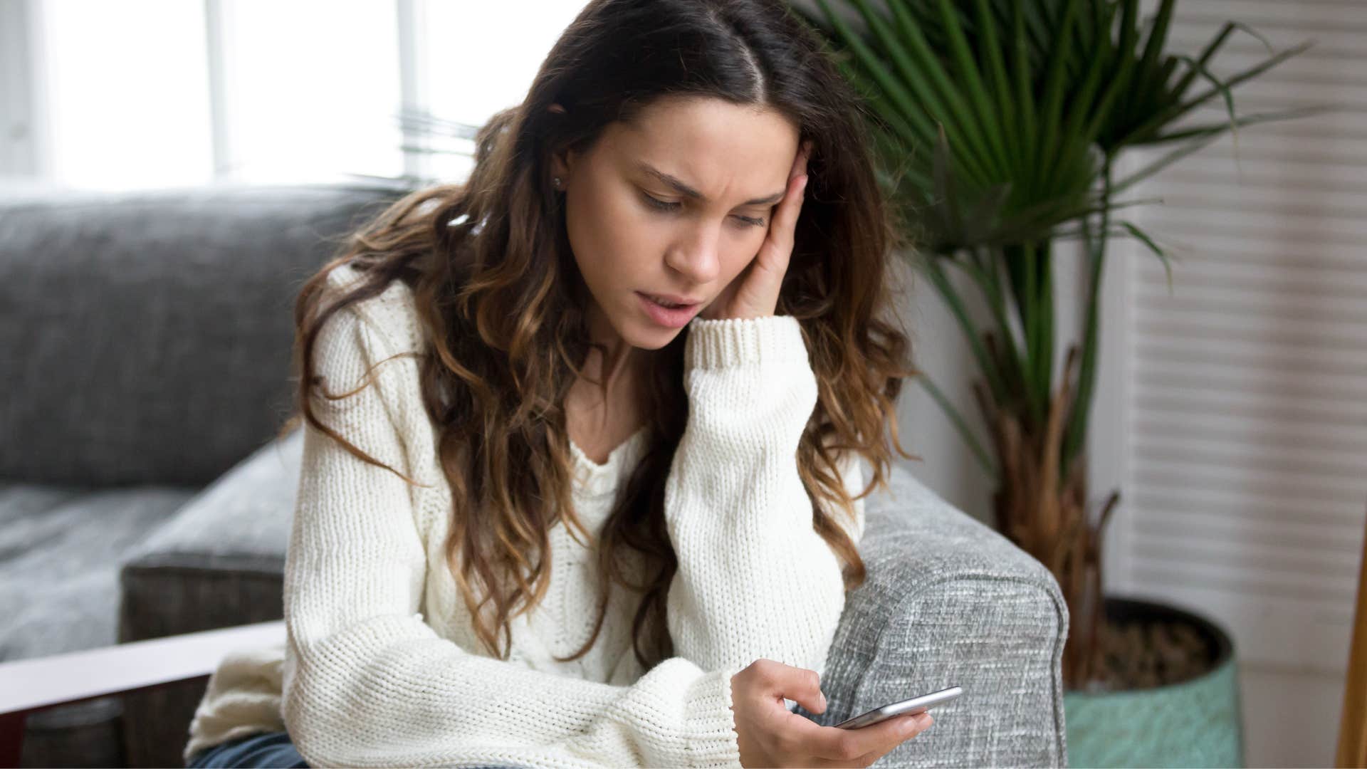 woman thinking about text message reply