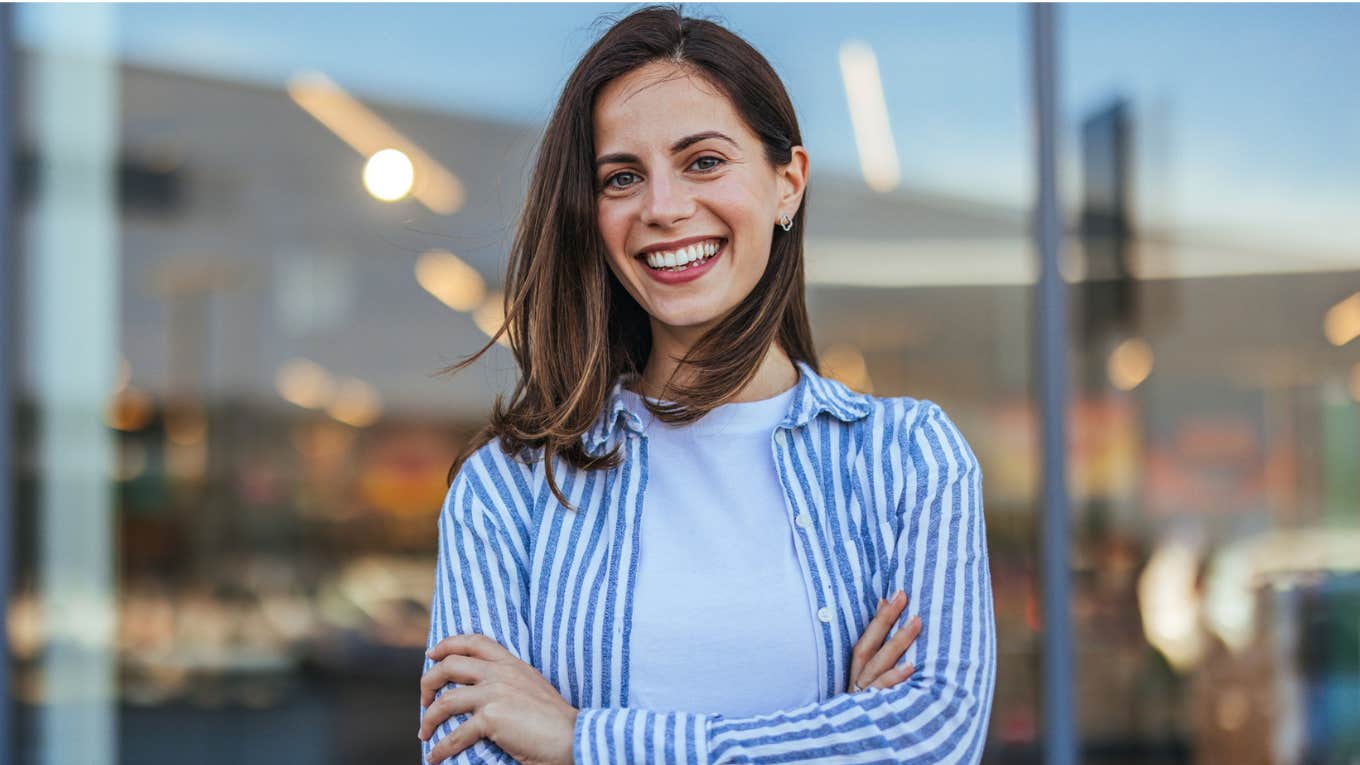 classy woman smiling arms crossed