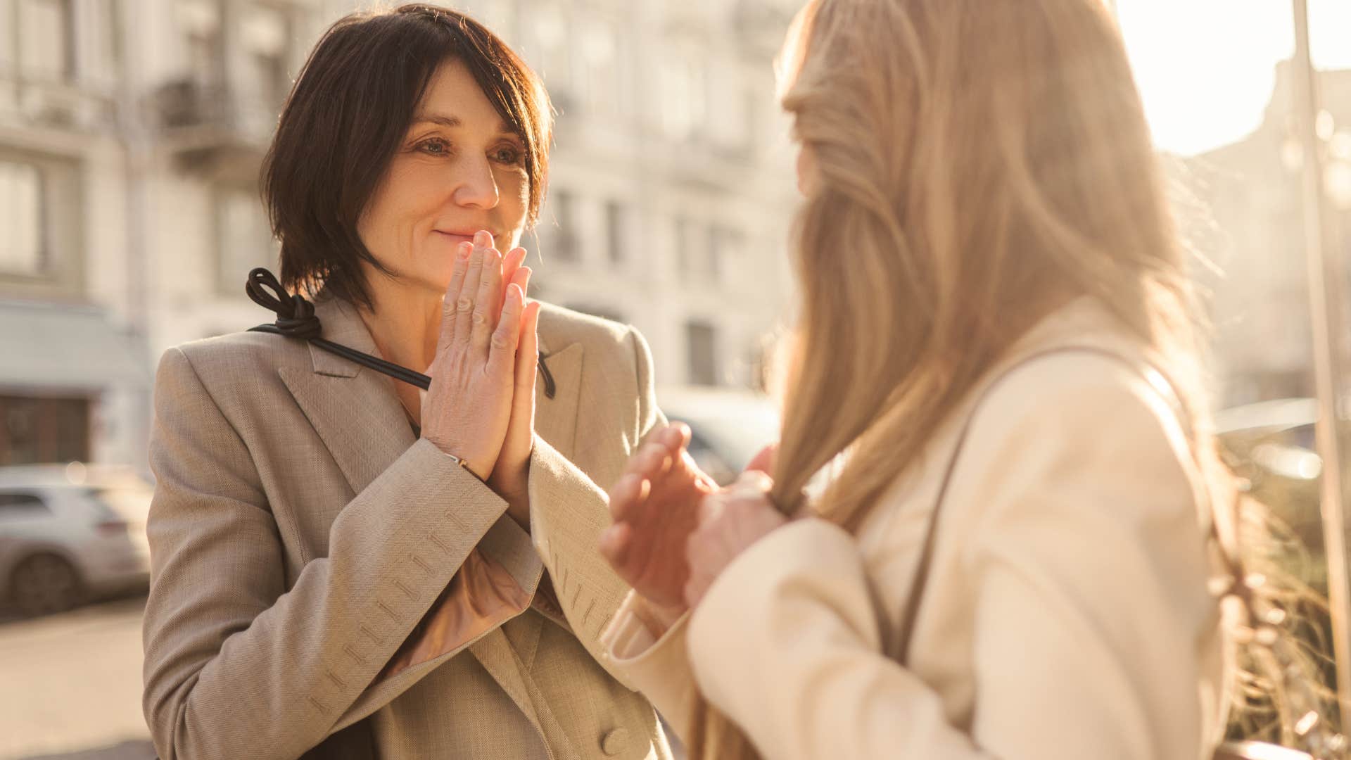 woman smiling while talking to a friend