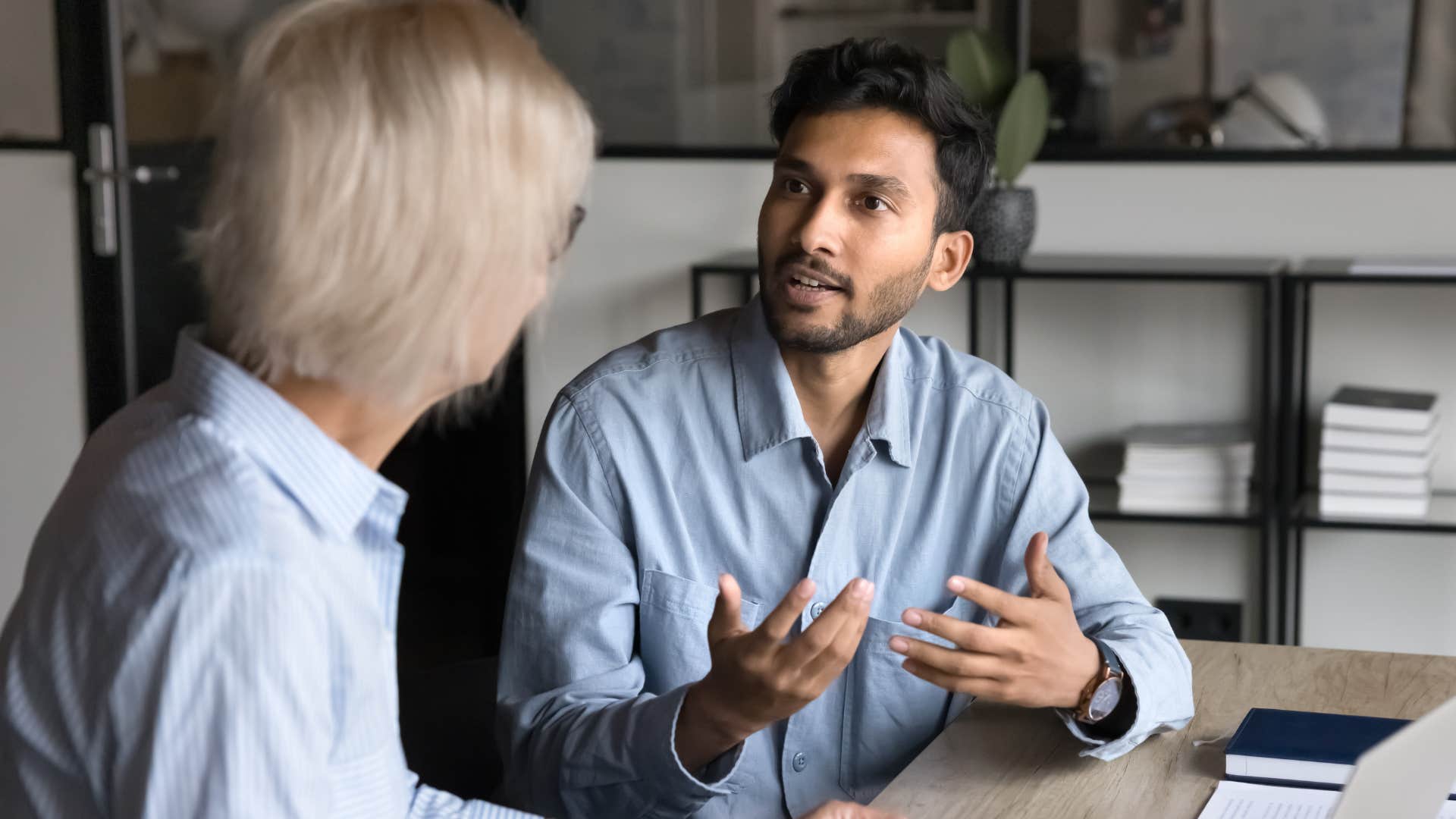 Professional man talking to a peer at work