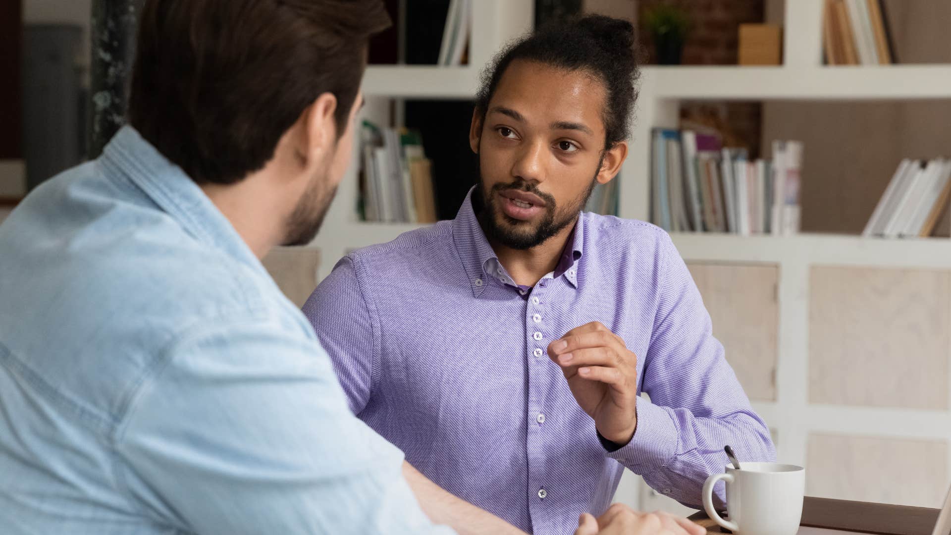 Two male co-workers talking in an office