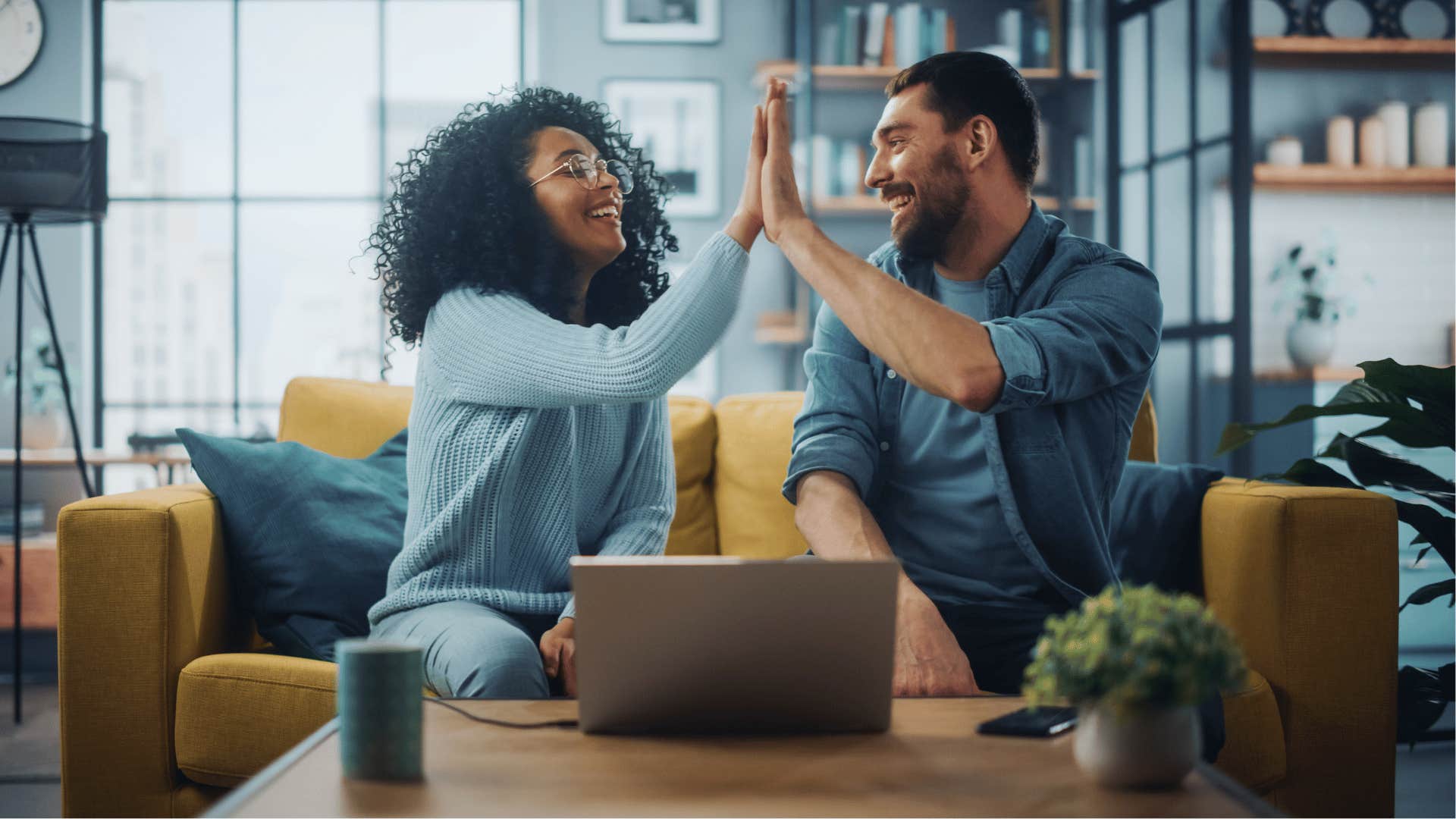 Optimistic couple gives each other a high five