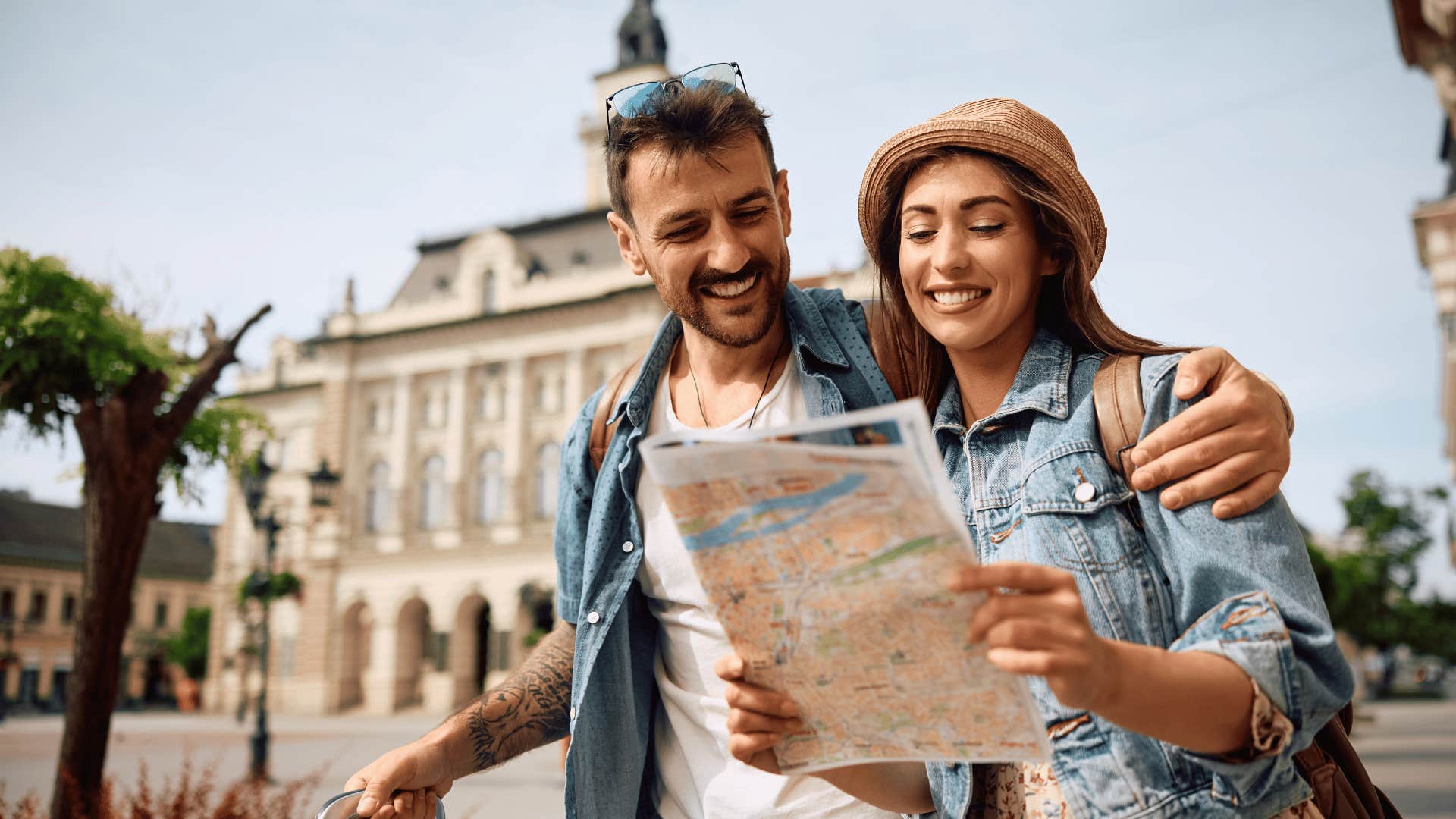 couple on a trip holding a map