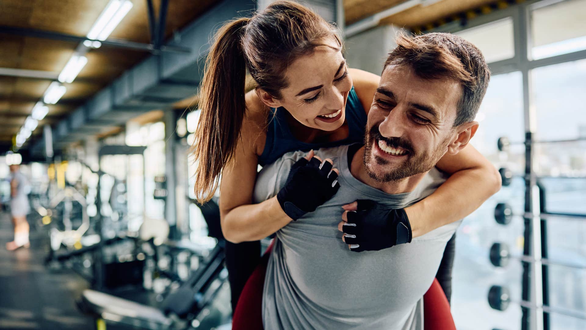 Happy couple smiling in the gym together.