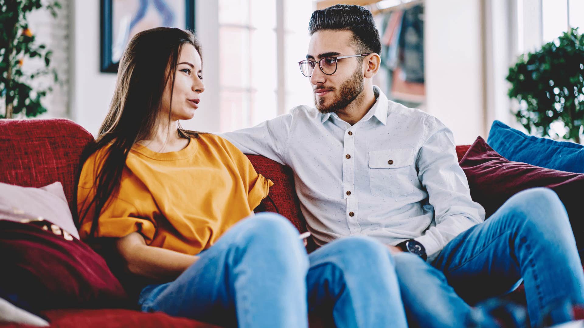 couple talking and being vulnerable on the couch