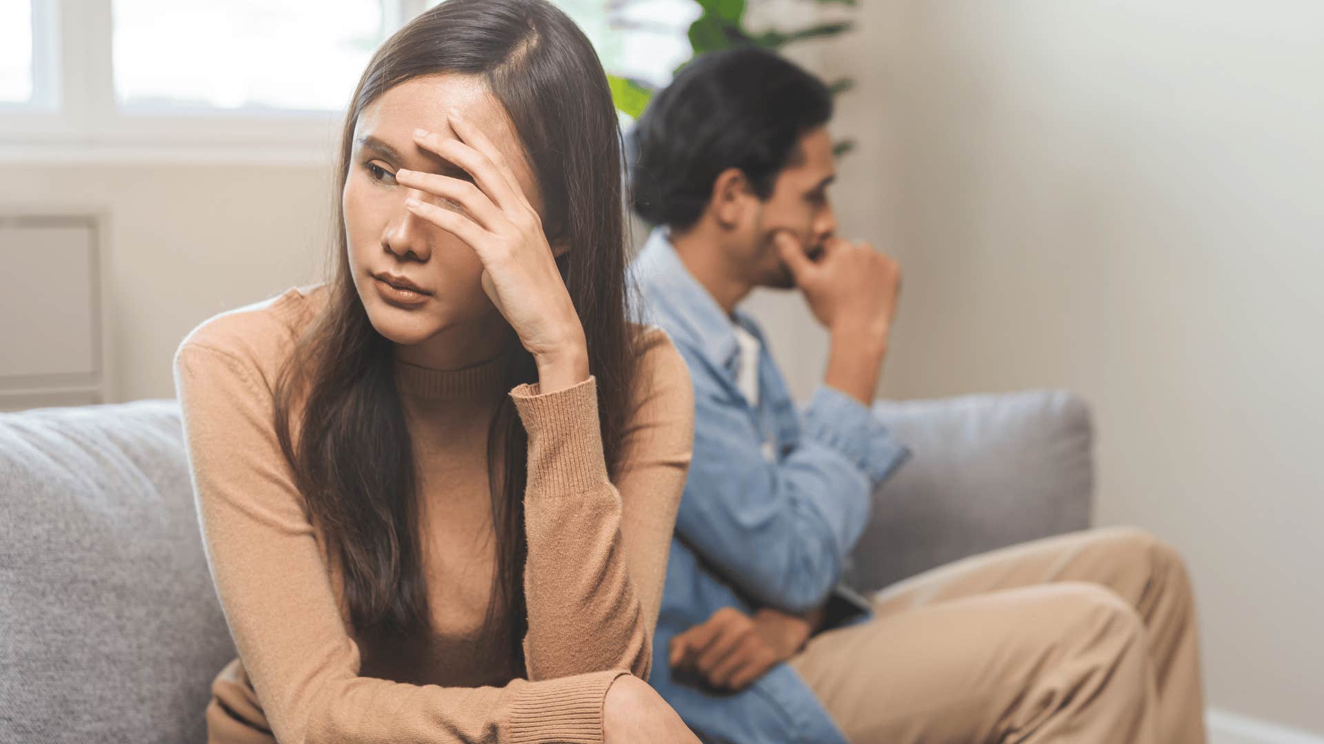 couple not talking to each other on couch