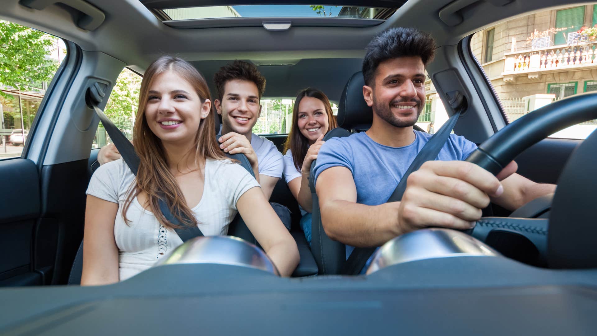 Woman riding shotgun in a car with friends