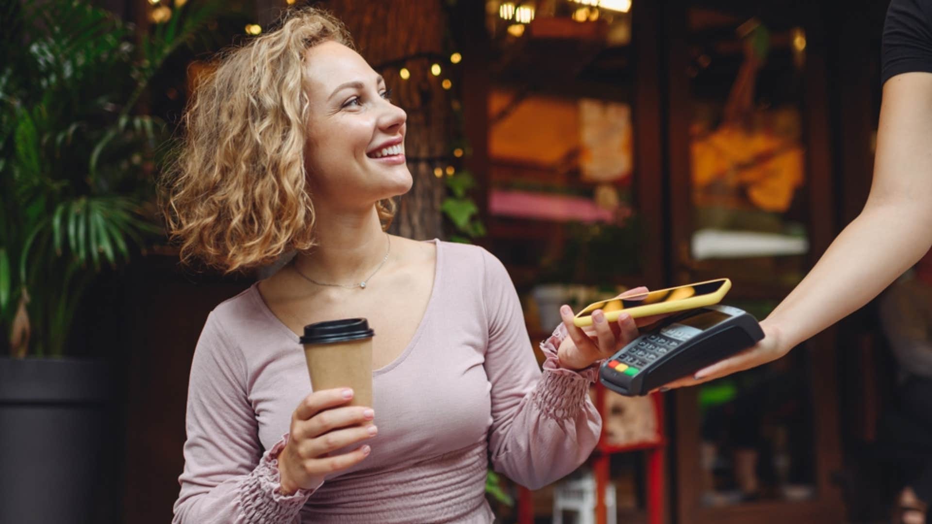 woman buying coffee from cafe 