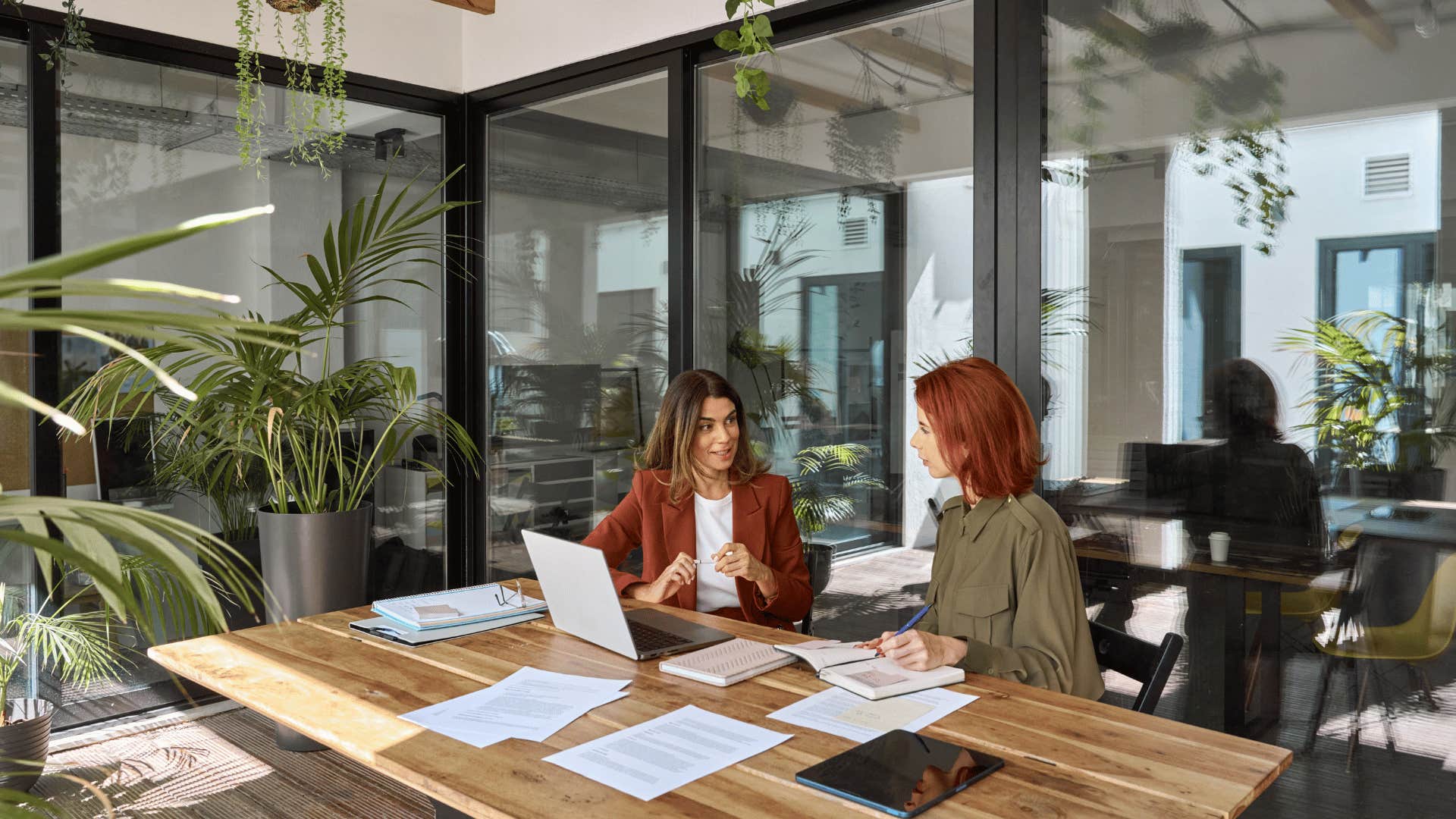 woman speaking to another woman in meeting roon