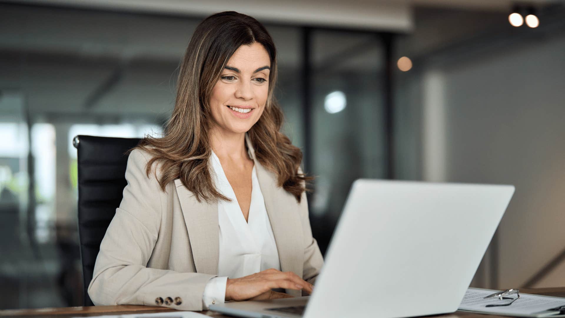 woman smiling while on laptop