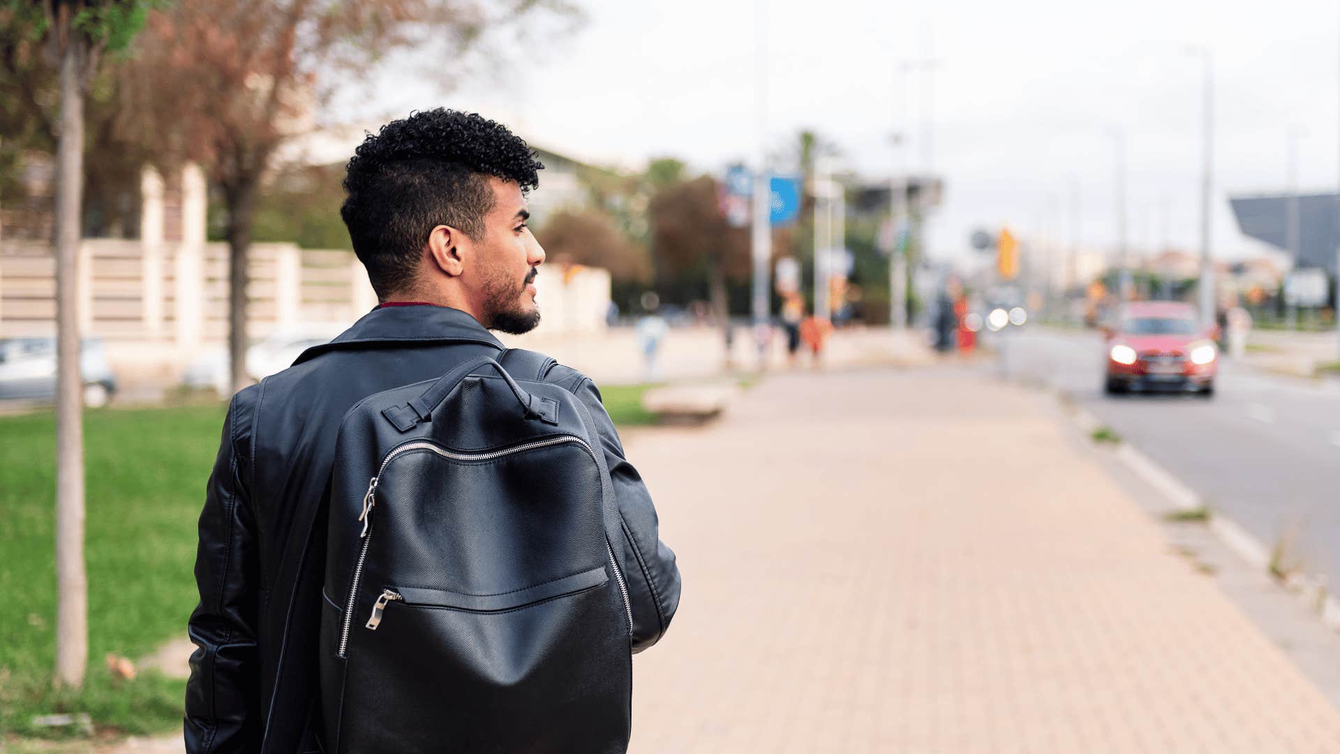 man walking through city