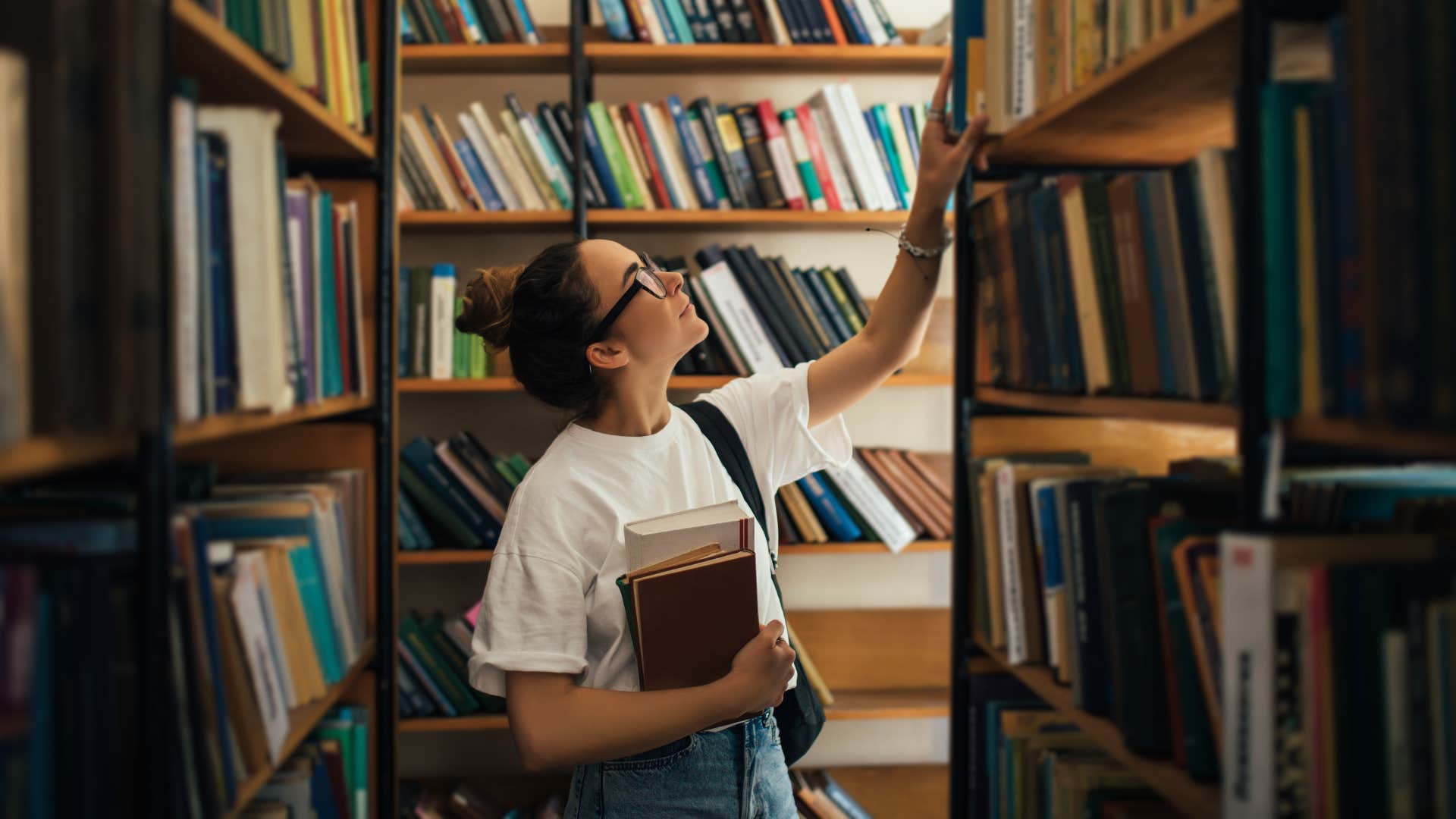 Woman getting books from her public library to read