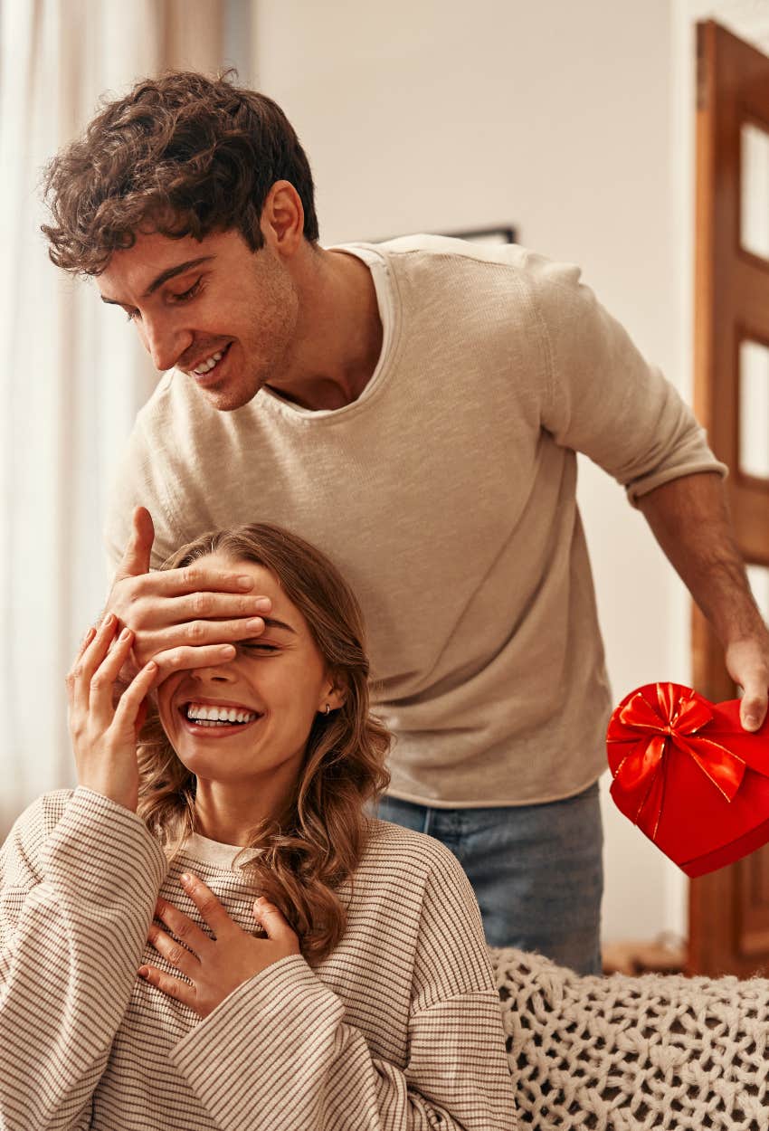 Man giving his girlfriend a Valentine’s Day gift