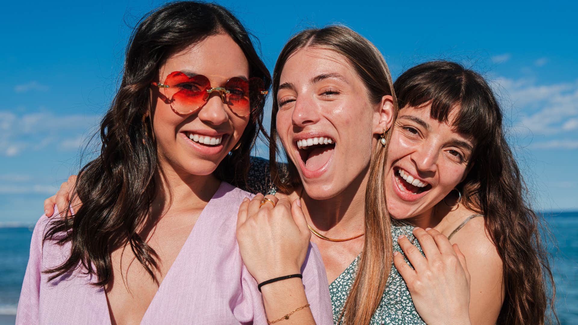 Group of only women taking a selfie portrait on the beach on her summer vacations