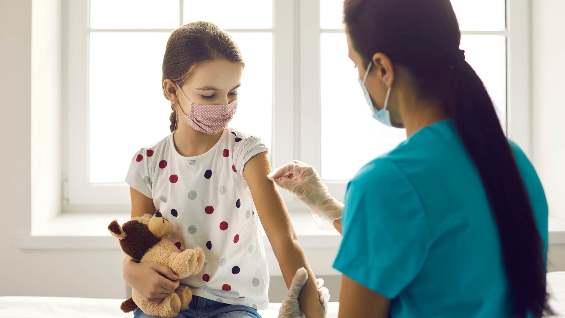 Child getting vaccinated because her parent knows the critical fact that vaccines saves lives