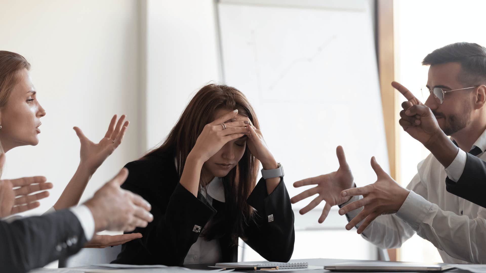 men arguing with frustrated woman