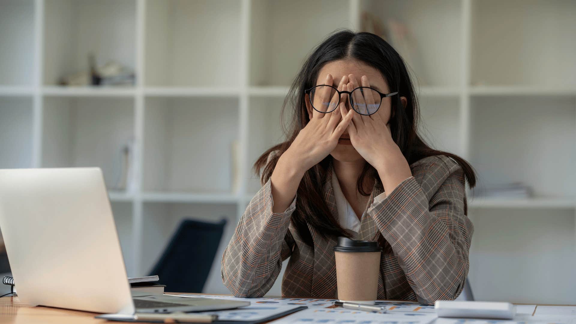 tired woman in front of laptop