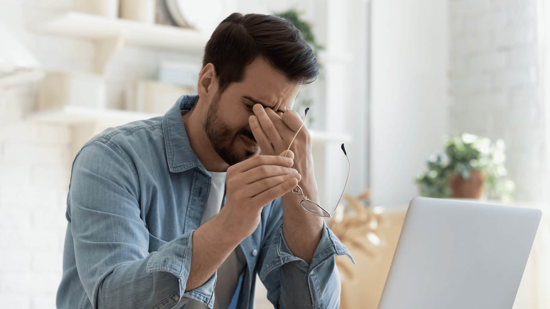 tired man in front of laptop