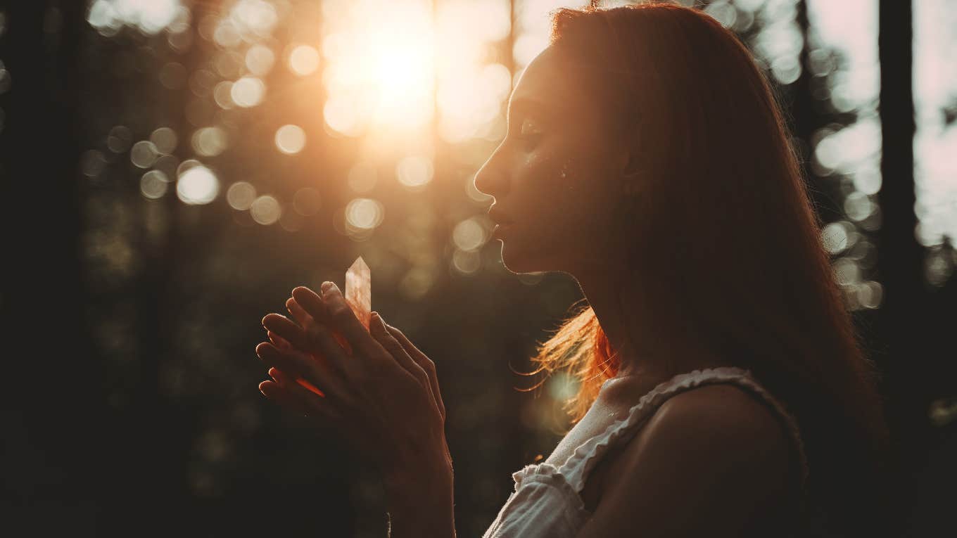 Woman using a crystal to attract money and success