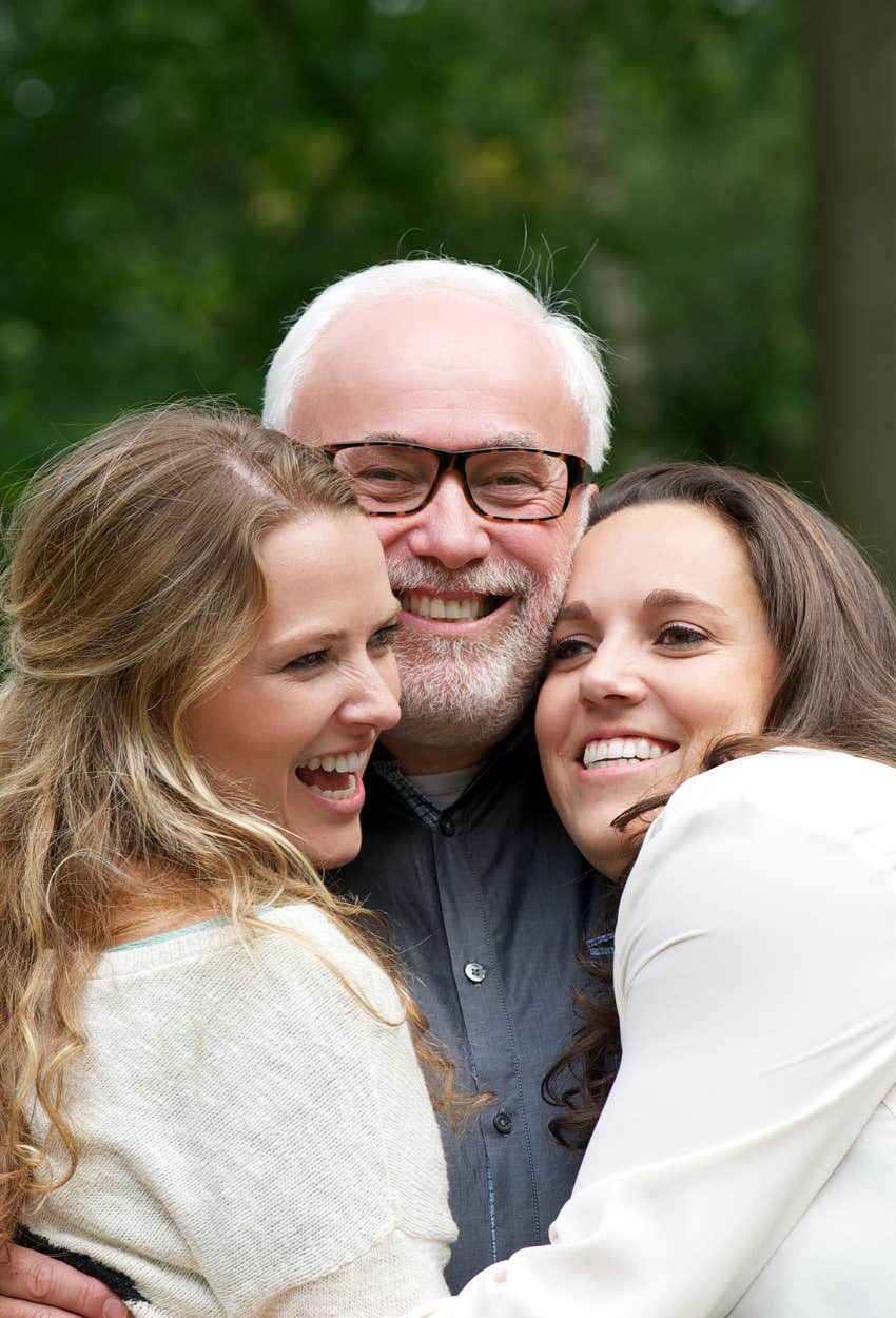 dad hugging adult daughters threaten disown meet mom's partner