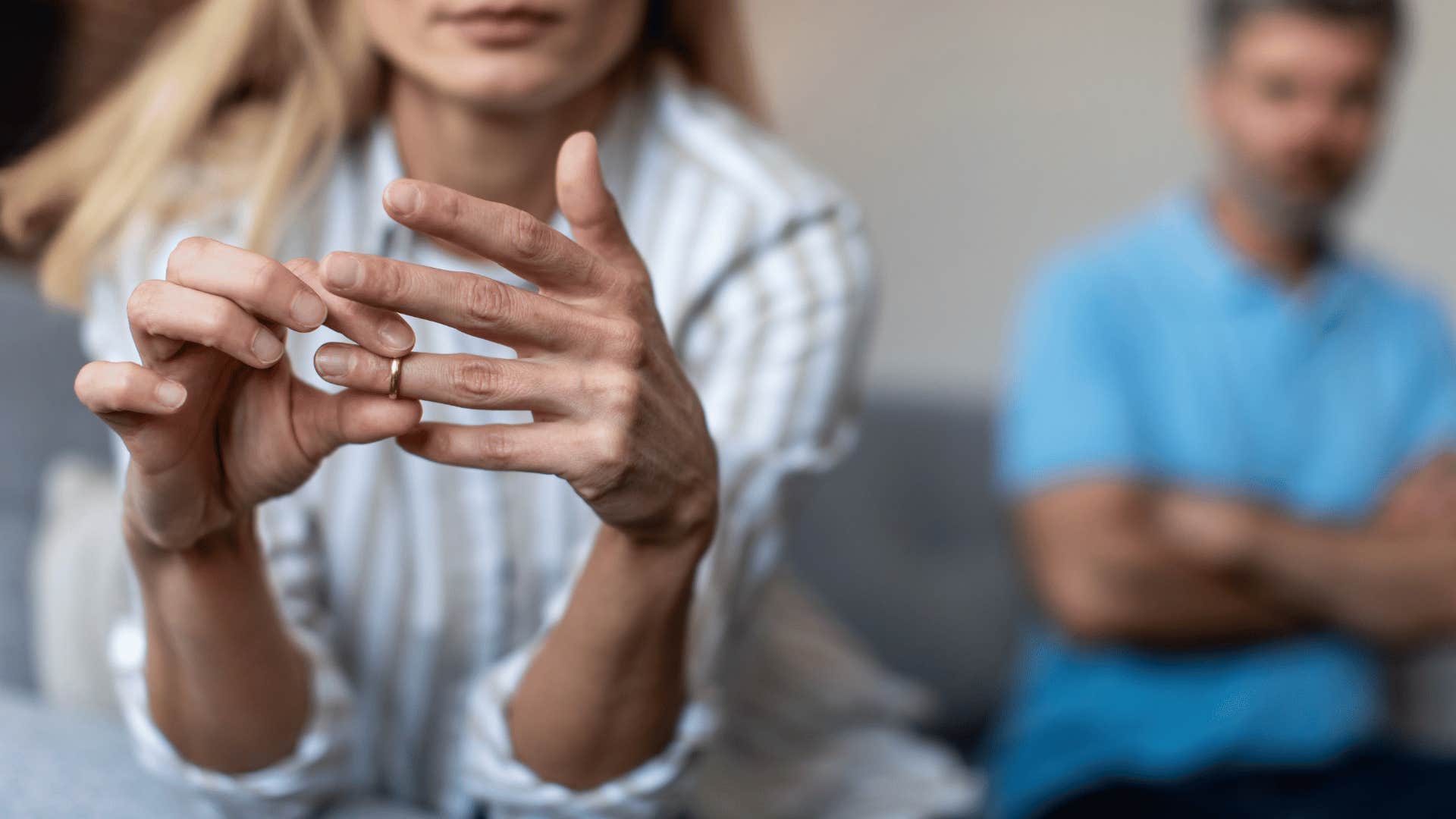 woman taking off wedding ring