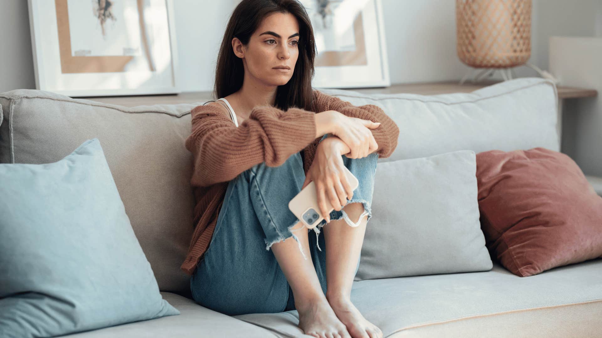 upset woman sitting on couch