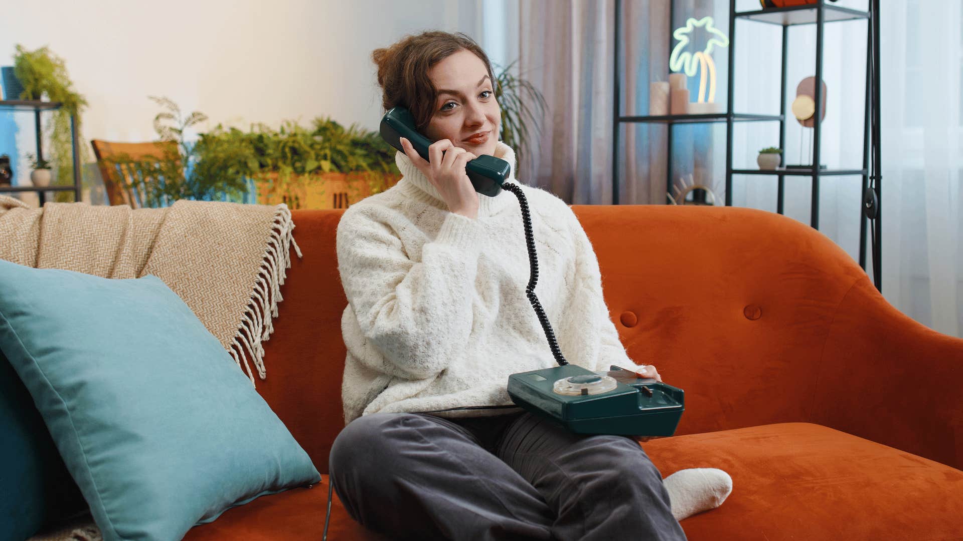 woman using wired telephone