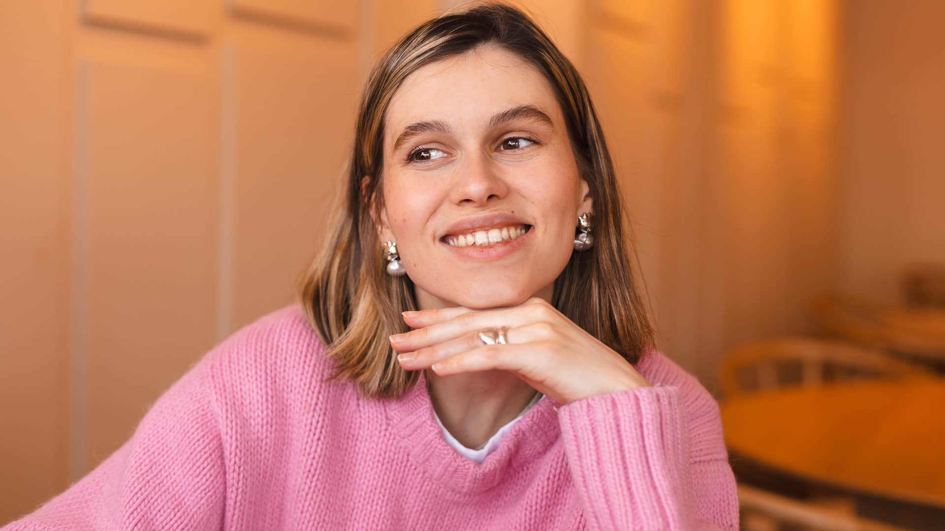 charismatic woman smiling wearing pink