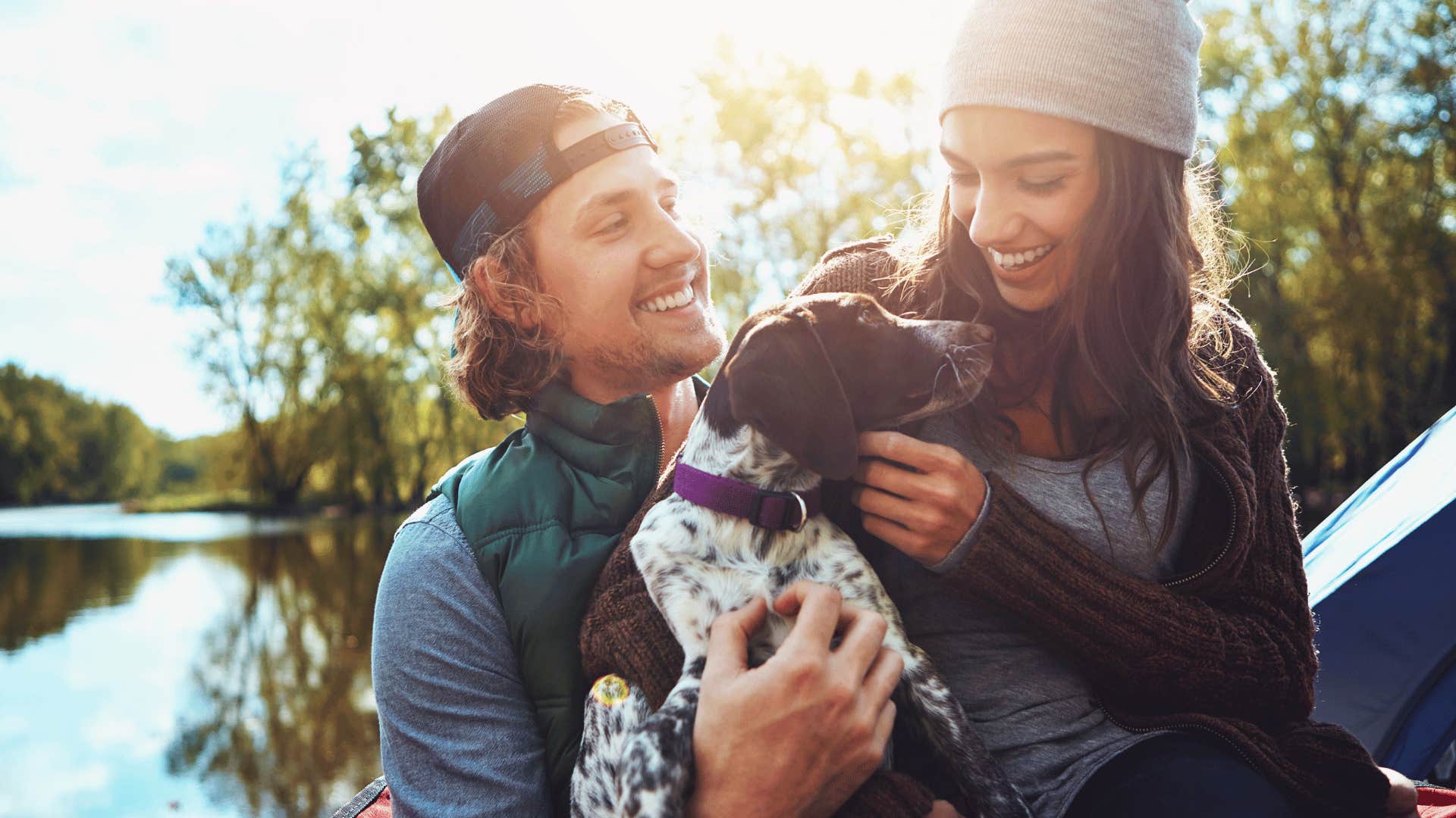 couple with dog in nature