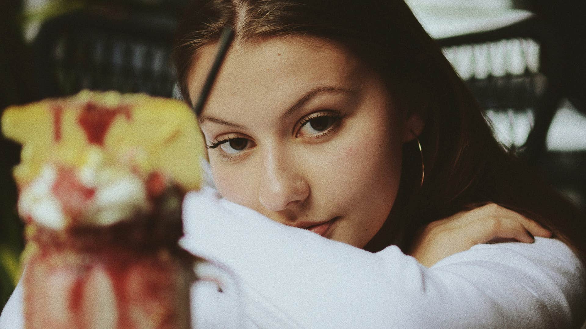 disappointed woman drinking milkshake