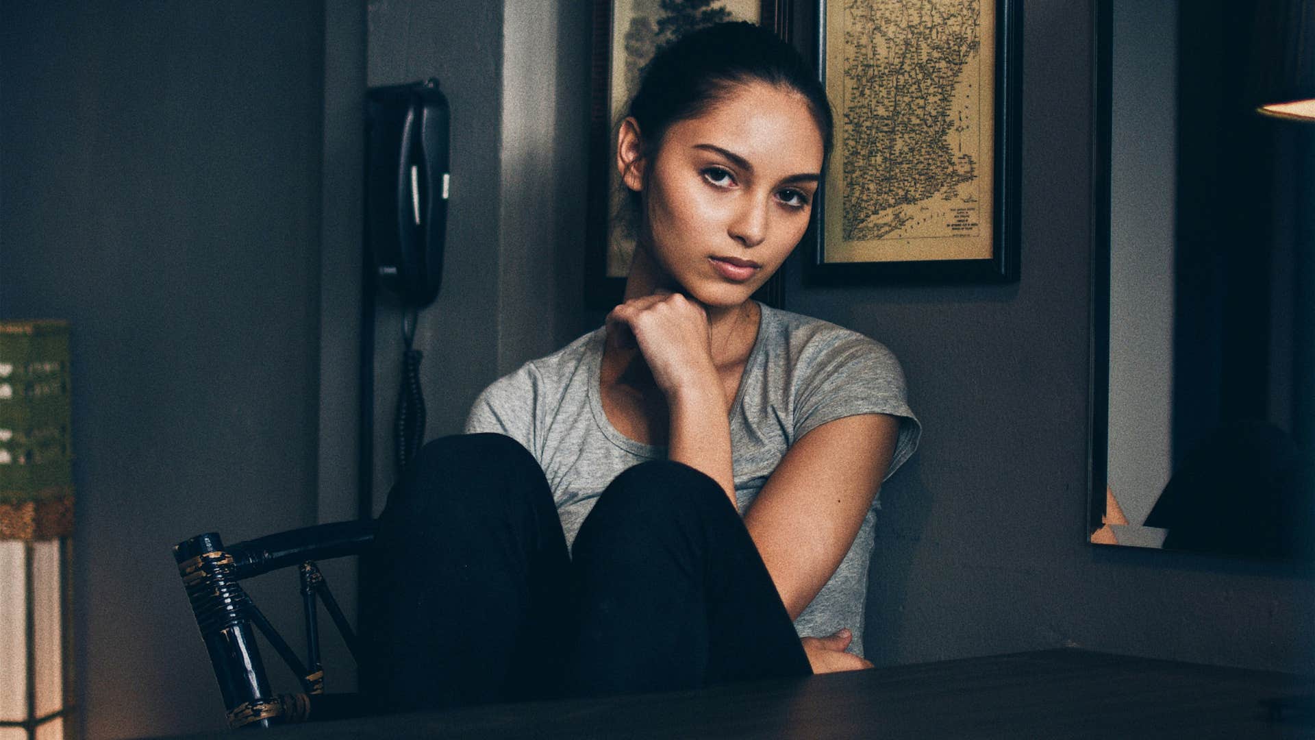 serious woman sitting at a table