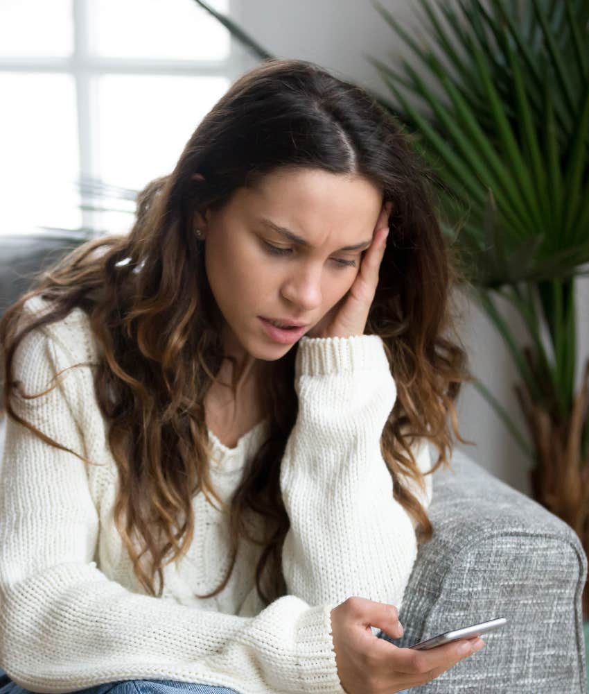 stressed woman looking at her phone after best friend had baby