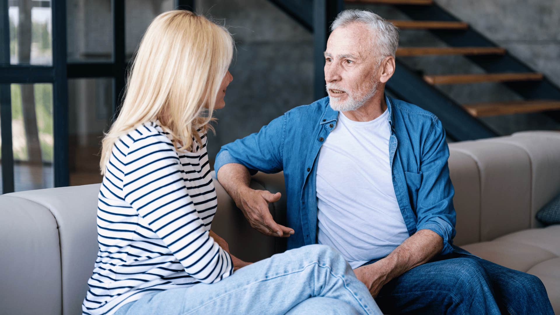 older couple talking on couch