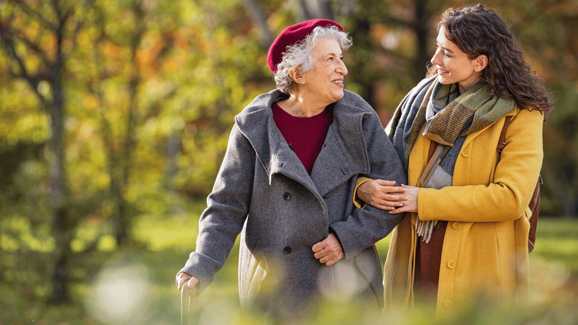 woman helping older woman walk