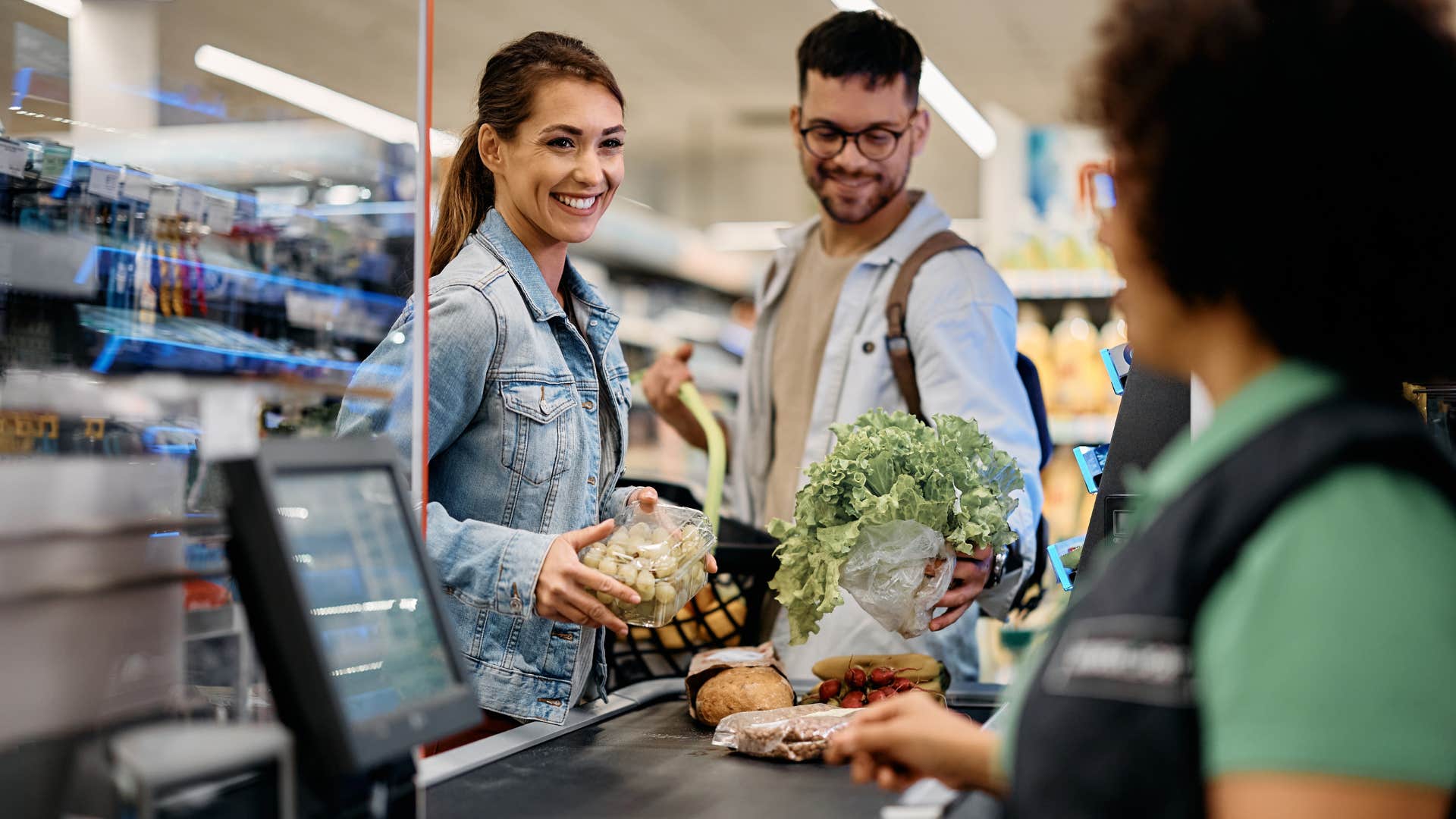 couple paying for groceries at a checkout counter