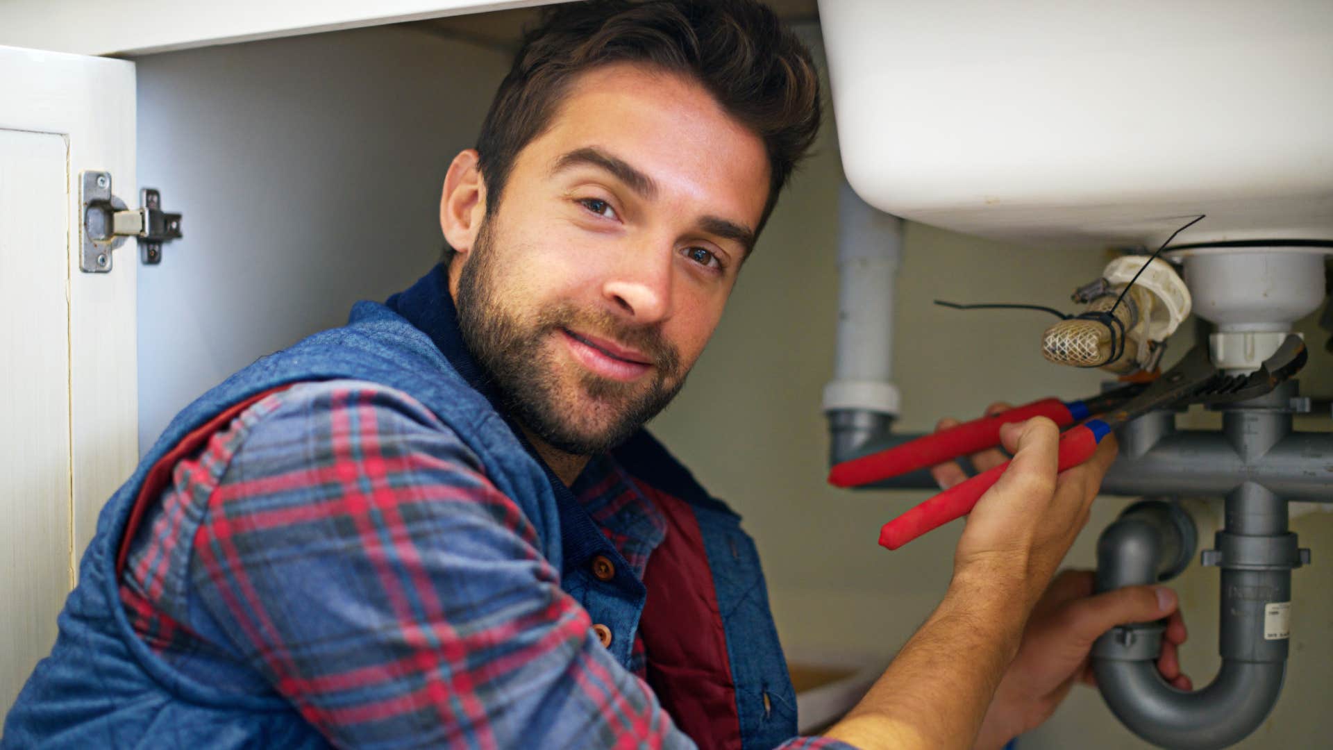 man fixing his sink