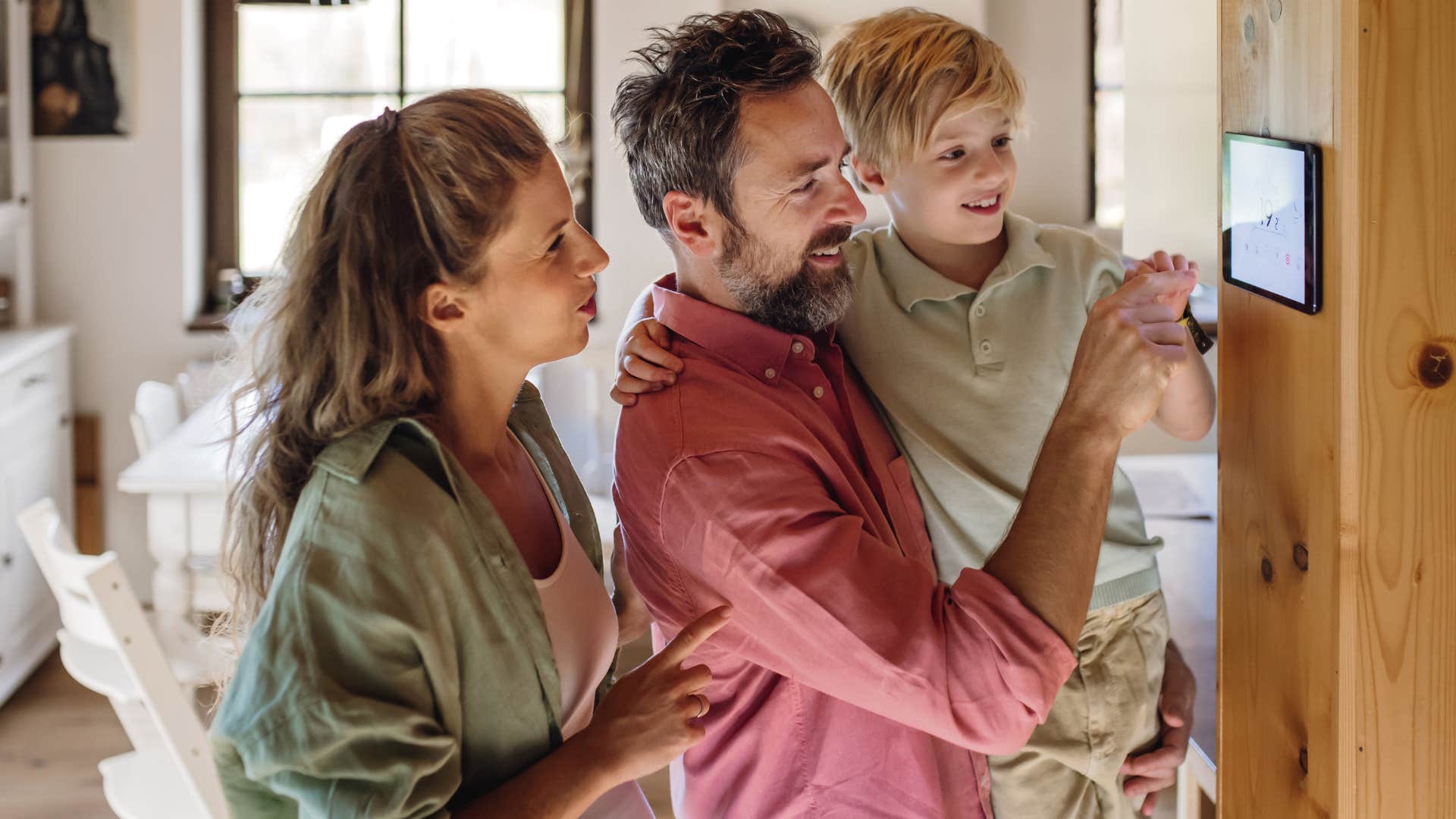 family looking at a thermostat