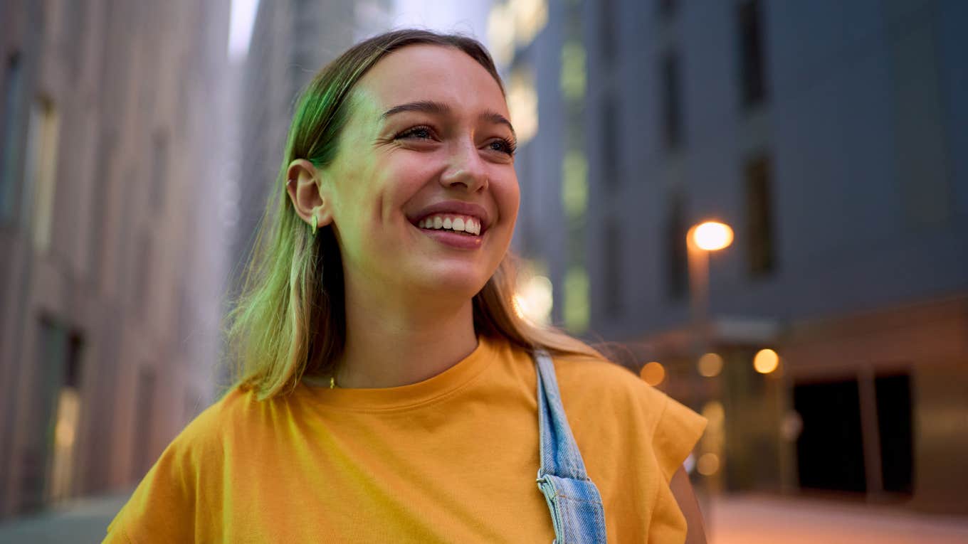 Gen Z woman walking on the street in a big city