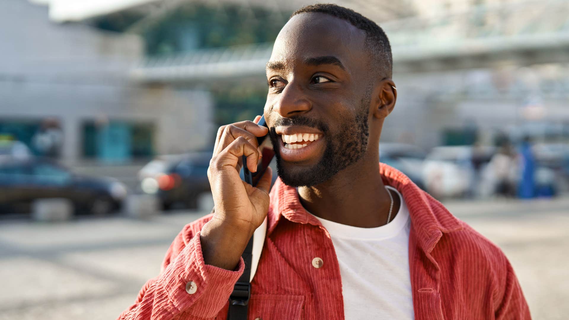 man smiling talking on the phone