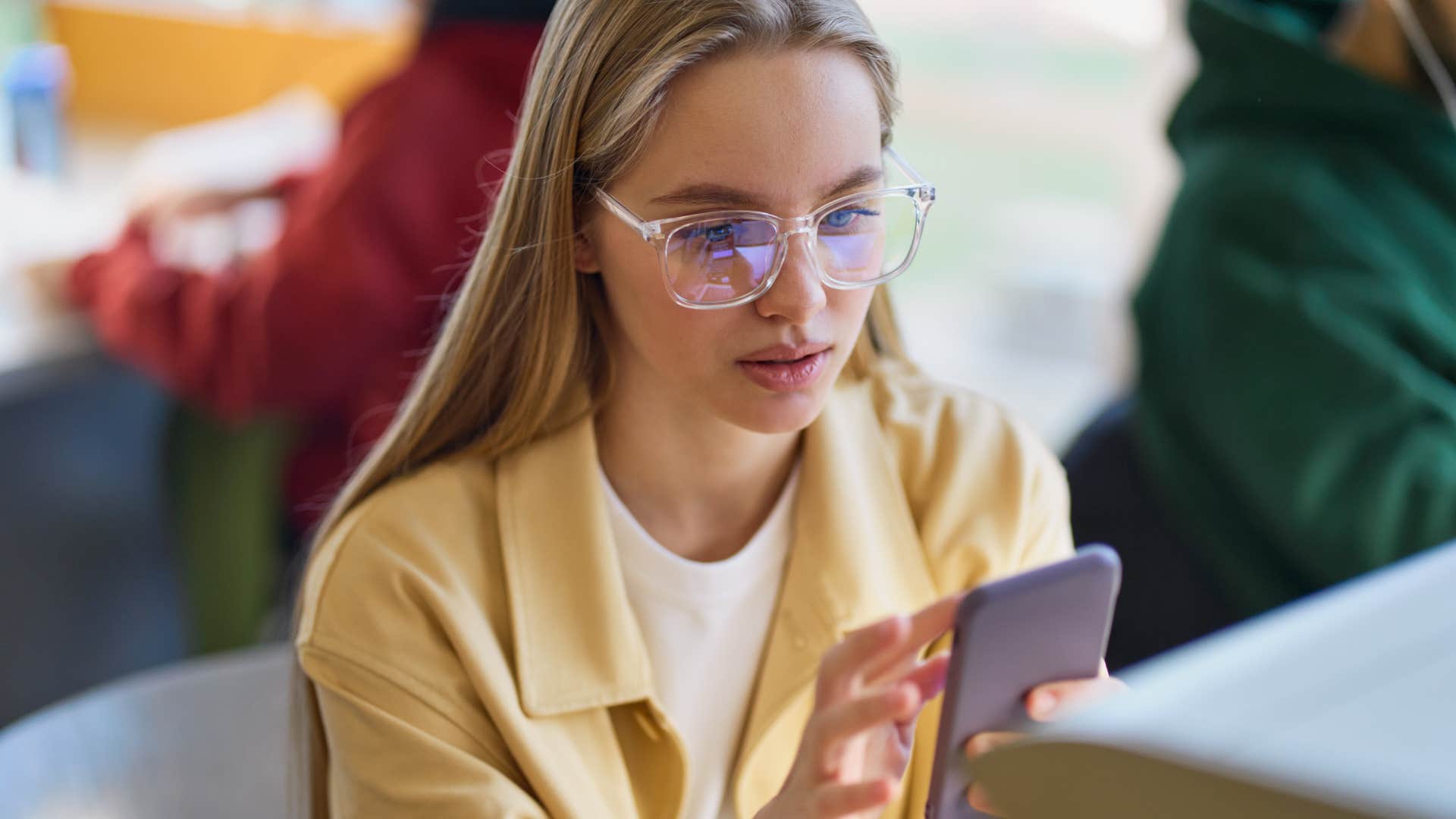 concentrated woman typing on her phone