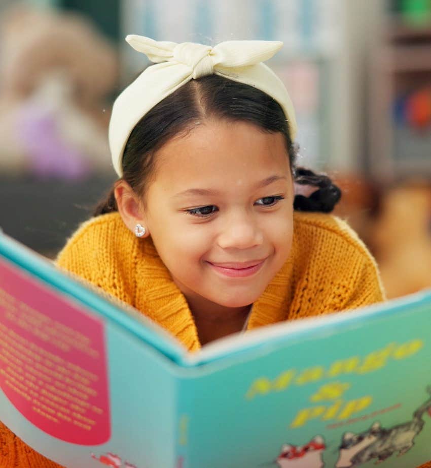 Adolescent child reads book and loves learning