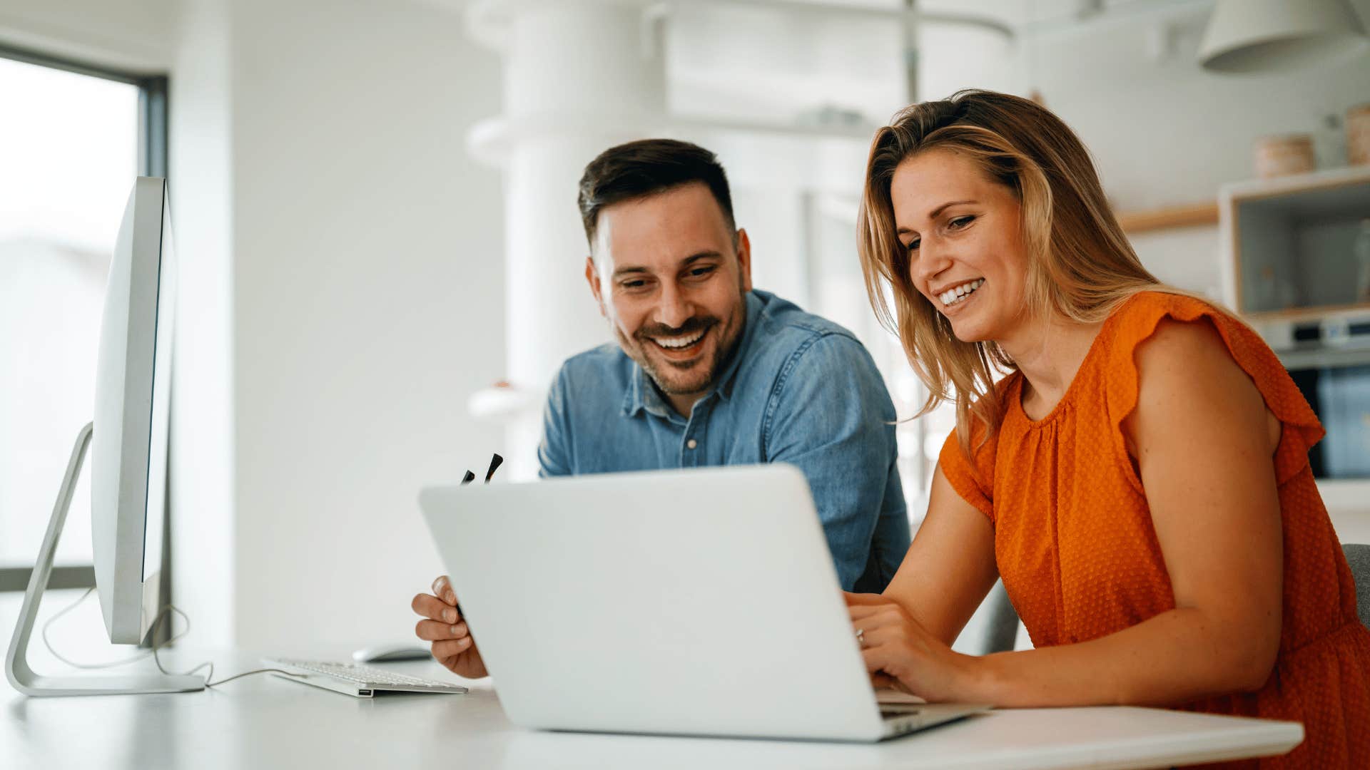 couple in front of laptop