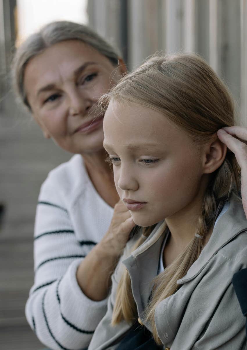 grandmother doing her granddaughter's hair