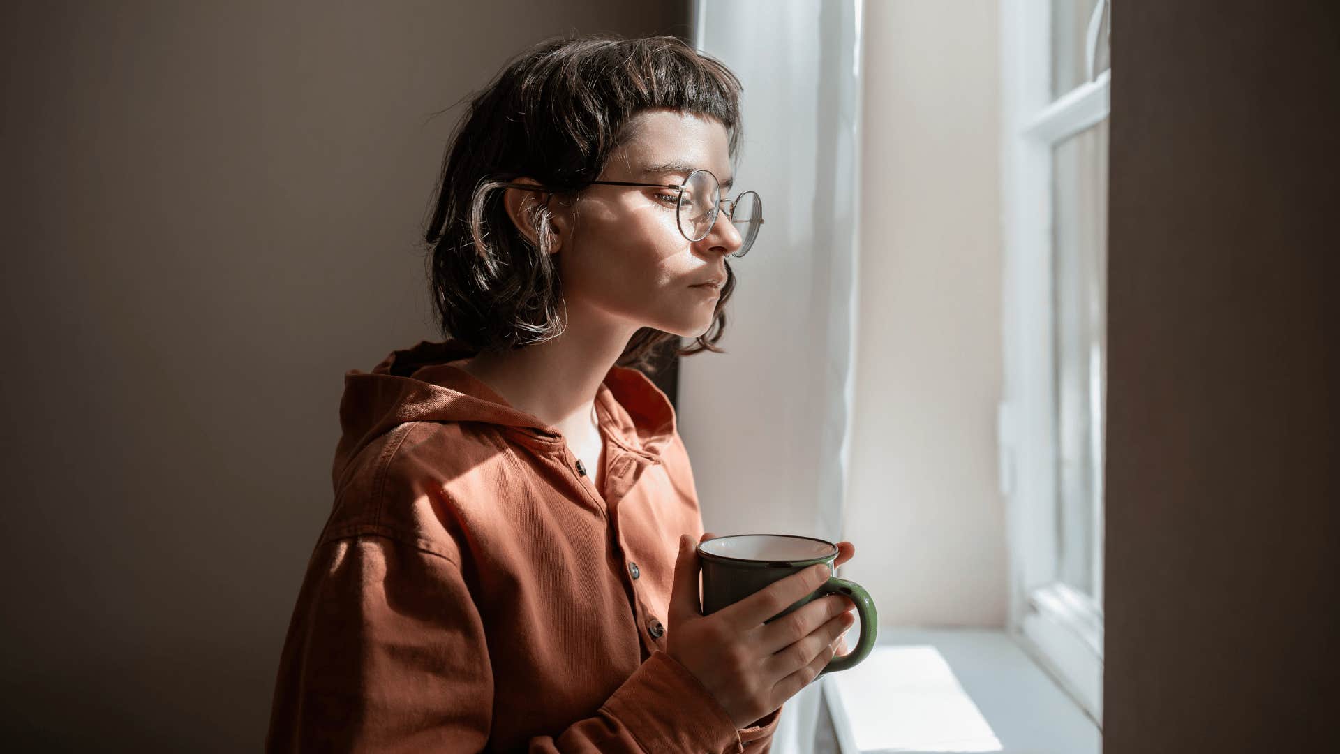 woman looking out window