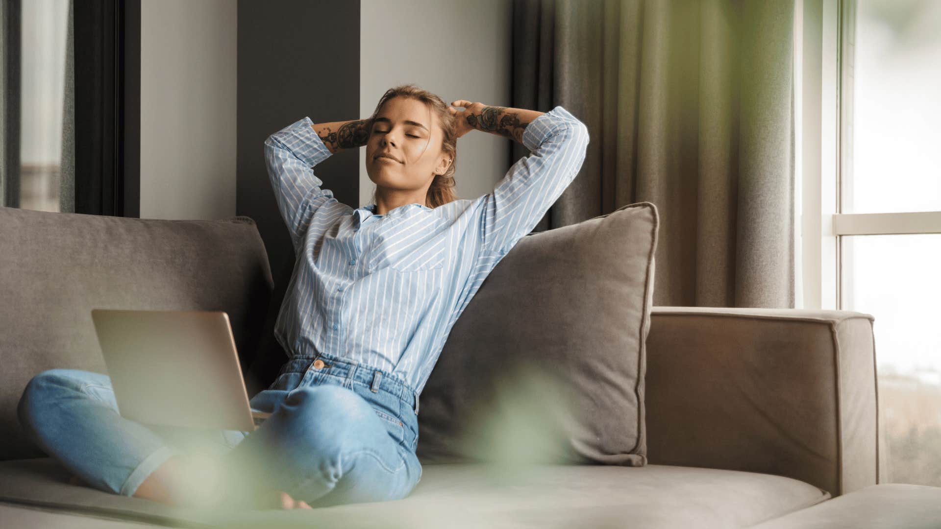 woman relaxing with laptop on lap